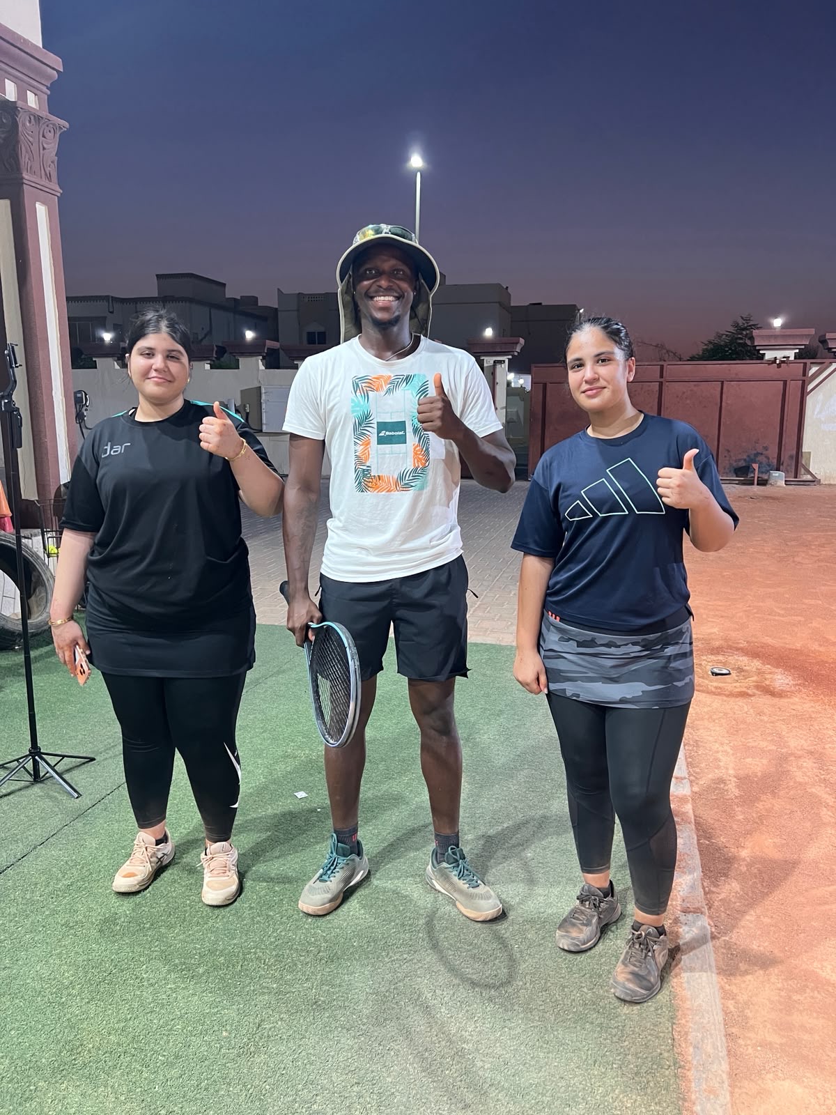 Coach Frank with two players after an evening group session